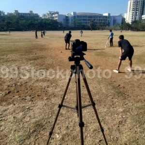 Camera on a Tripod recording game of cricket