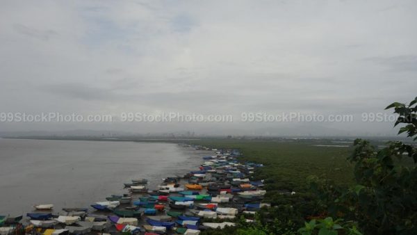 Monsoon View of Covered Boats on Beach