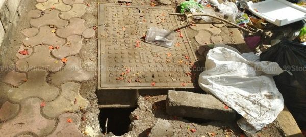 Stock Photo of Man hole  and Garbage