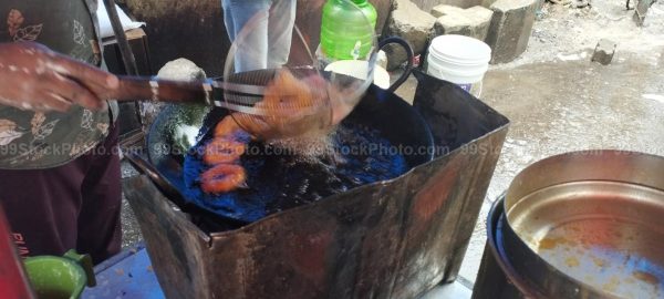 Stock Photo of Hawker Mendu Wada cooking Roadside Type 2