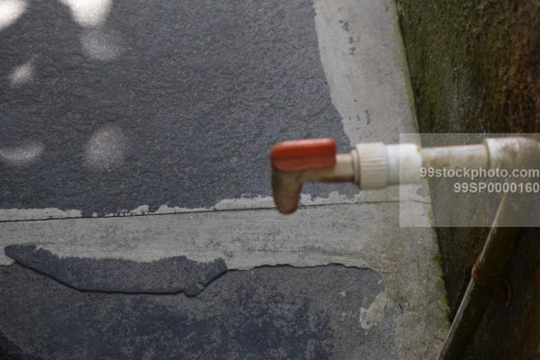 Stock Photo of Plastic Water Tap with Stone Flooring