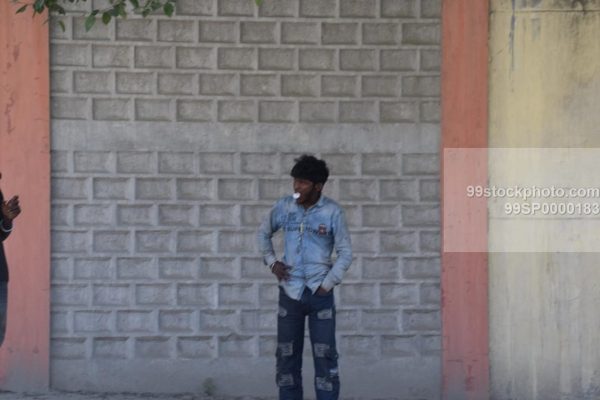 Stock Photo of Man Standing and Blowing Chewing Gum