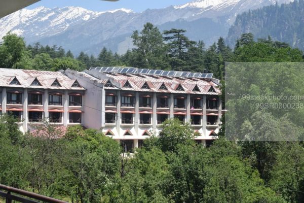 Stock Photo of  Distant View of Hotel in manali with Snow Mountains