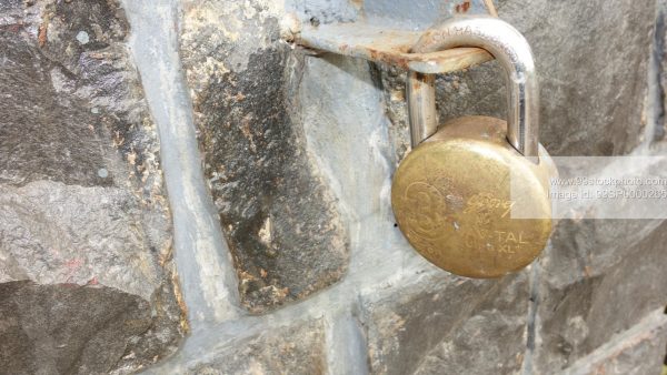 Stock Photo of Godrej Lock on Stone Wall