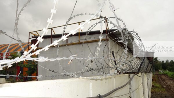 Stock Photo of Barbed Wire on a Compound Prison