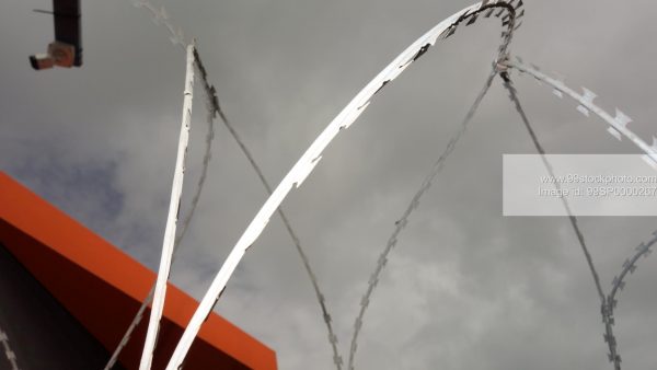 Stock Photo of Barbed Wire With Monsoon Clouds