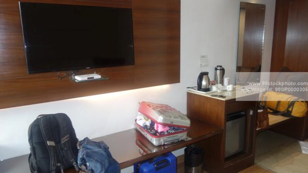 Stock Photo of Hotel Room of Tourist with Luggage Spreadover