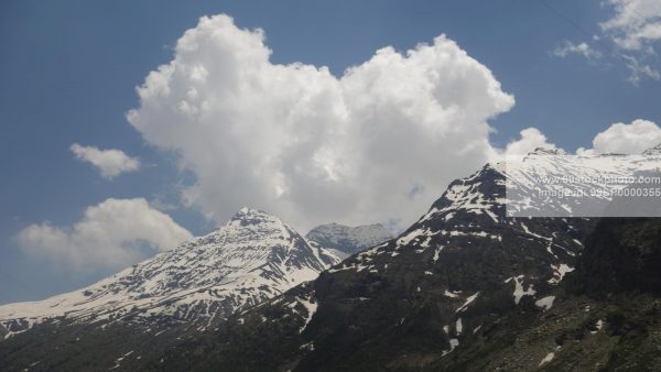 Stock Photo of Clouds Snow Hills and Pine Trees Type 4