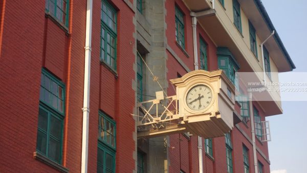 Stock Photo of Roman Character Clock on a Building in Shimla